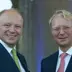 two European guys are smiling together.